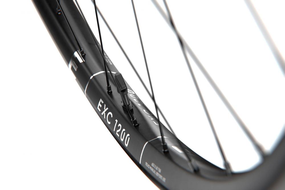 DT Swiss EXC 1200 Carbon Hinterradfelge 27.5 Zoll, Nahaufnahme der schwarzen Felge mit Schriftzug und Speichen.