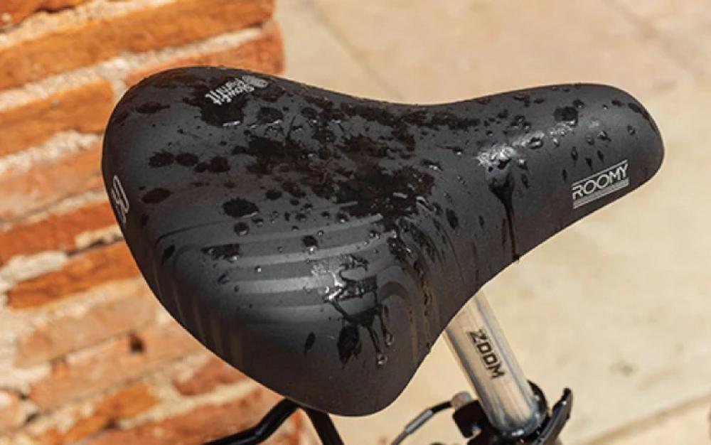 Selle Royal Roomy Moderate Unisex Fahrradsattel, schwarz, nass mit Wassertropfen.