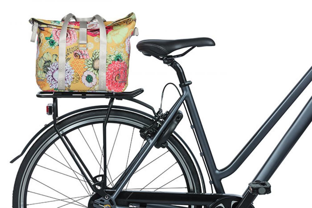 Bunte Basil Bloom Field Schultertasche in Honiggelb mit Blumenmuster am Fahrrad-Gepäckträger montiert.