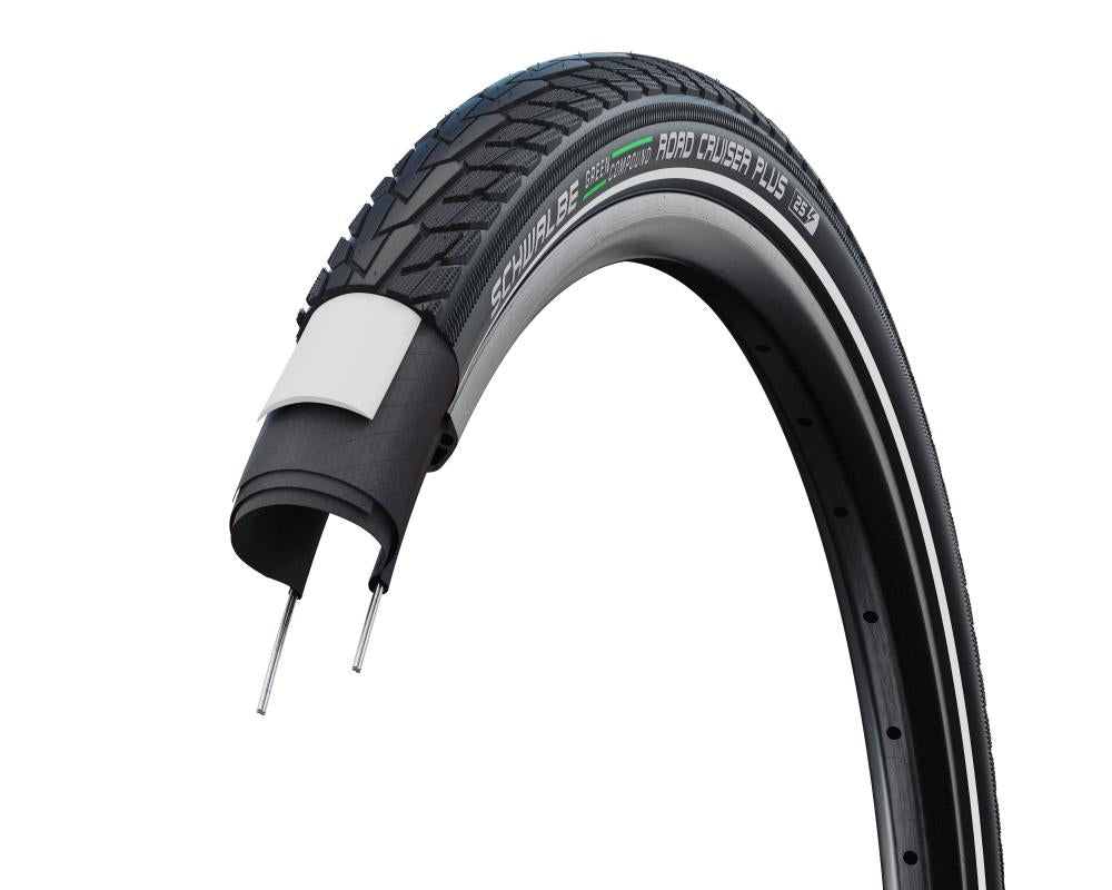 Schwalbe Road Cruiser Plus E-25 Fahrradreifen, schwarz, mit Reflexstreifen und Schnittansicht des Pannenschutzes.