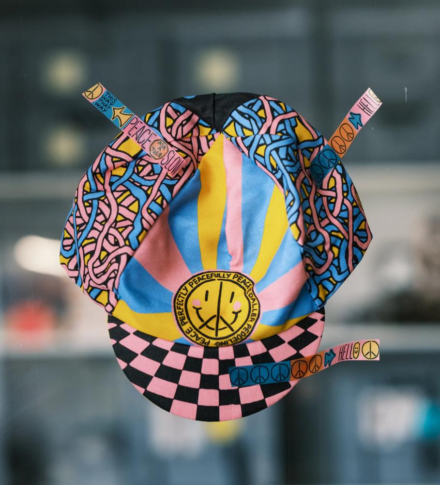 Ass Savers Cap BITS N' PEACES Special Edition: bunte Fahrradkappe aus Baumwolle mit Peace-Zeichen, Smiley und Schachbrettmust