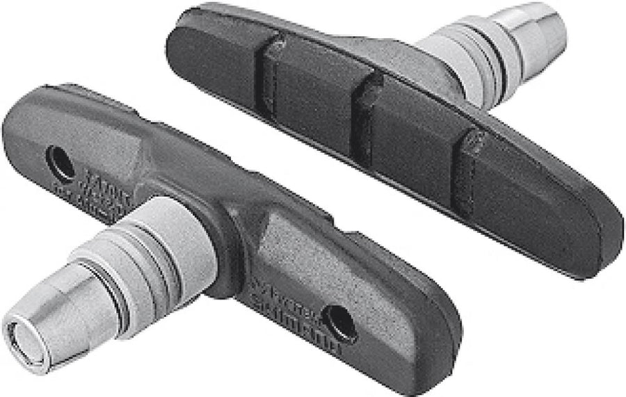Zwei schwarze SHIMANO M70T4 MTB Bremsschuhe mit silbernen Befestigungsbolzen und Cartridge-Belägen für Alufelgen.